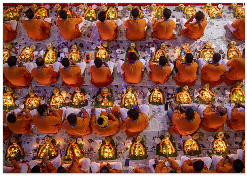 Devotees pray with light