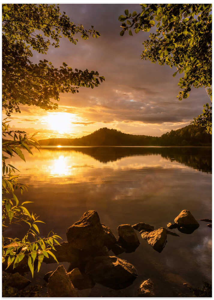 Sunset at a lake with a small mountain in the background