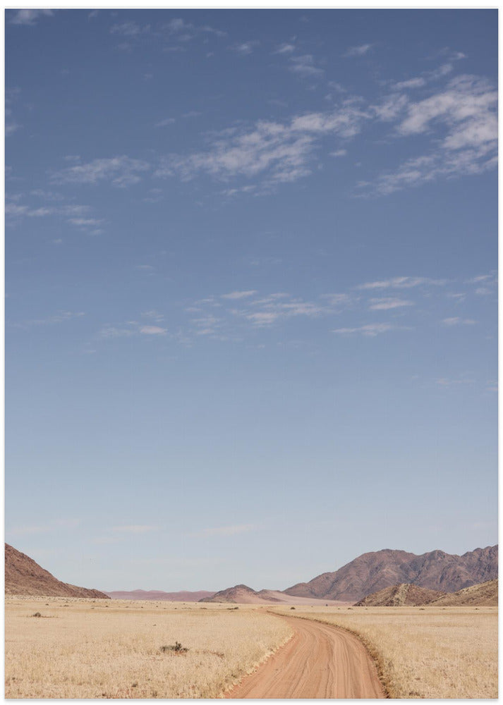 Vast Desert Road Under A Clear Blue Sky