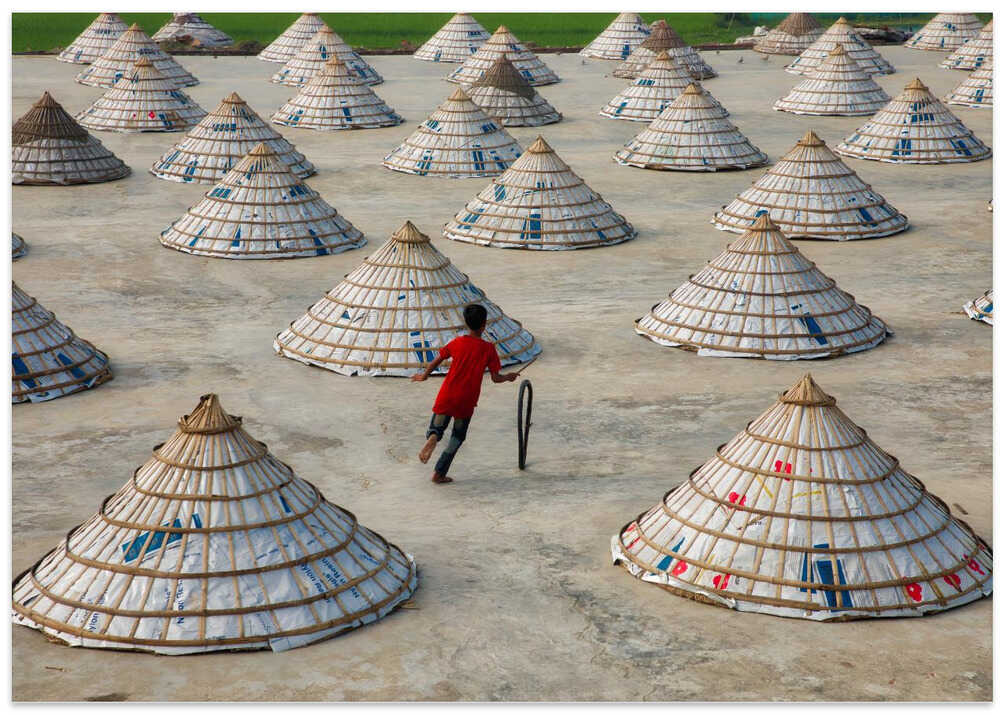 Children playing in the rice mill.