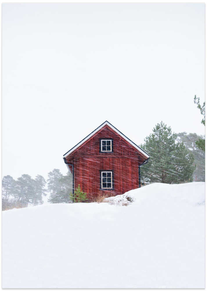 Old red house during snowstorm