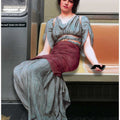 A Woman in Ancient Attire Seated in a Subway
